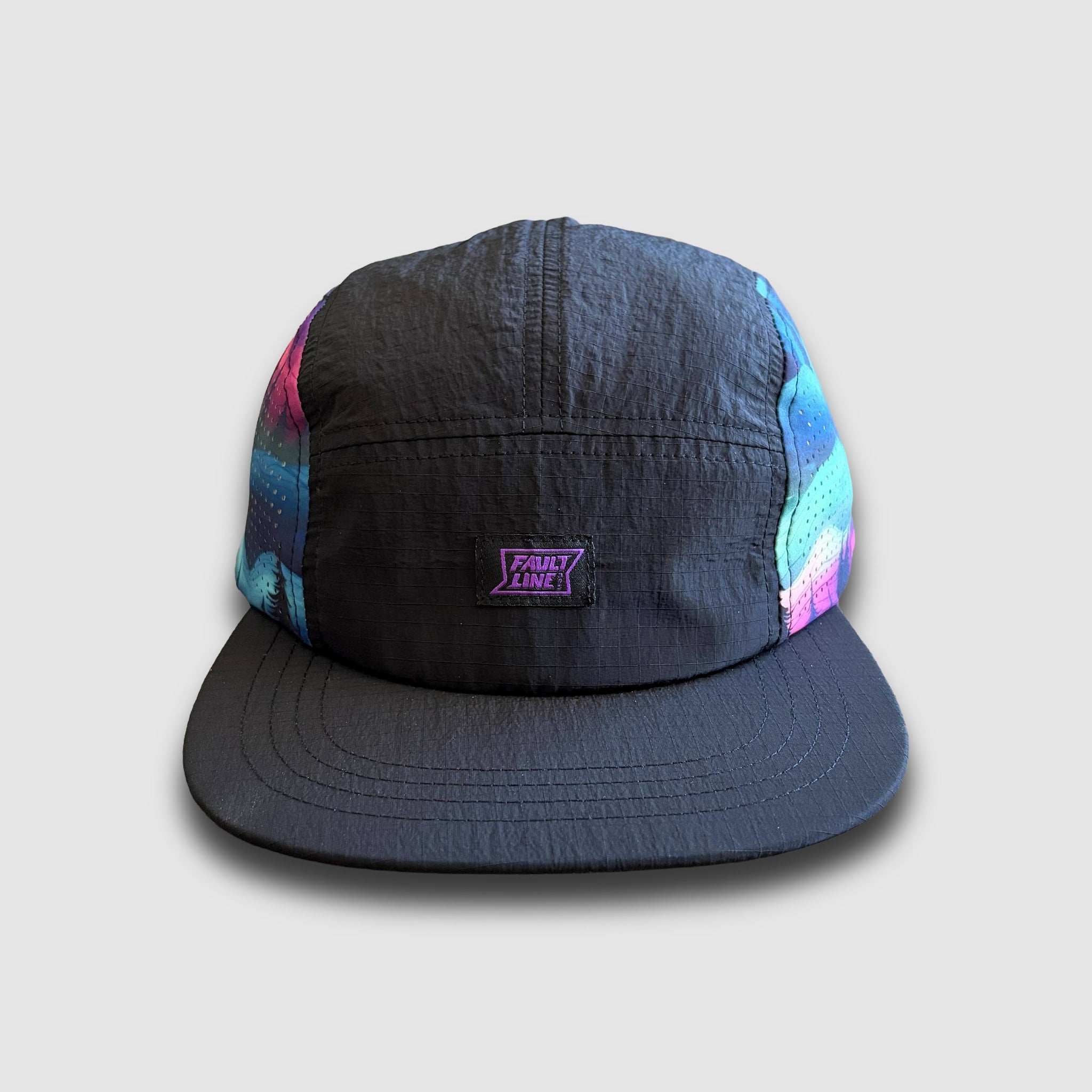 Black cap with colorful side panels and Faultline395 brand logo on a light gray background