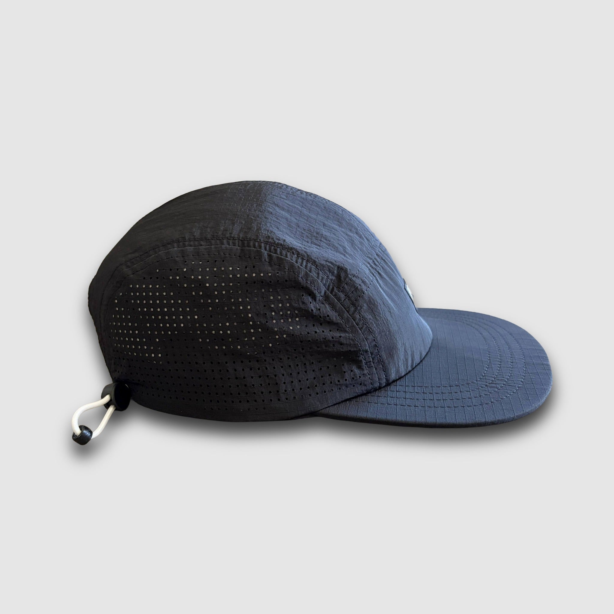 Side view of the Faultline395 crushable camper hat in black ripstop