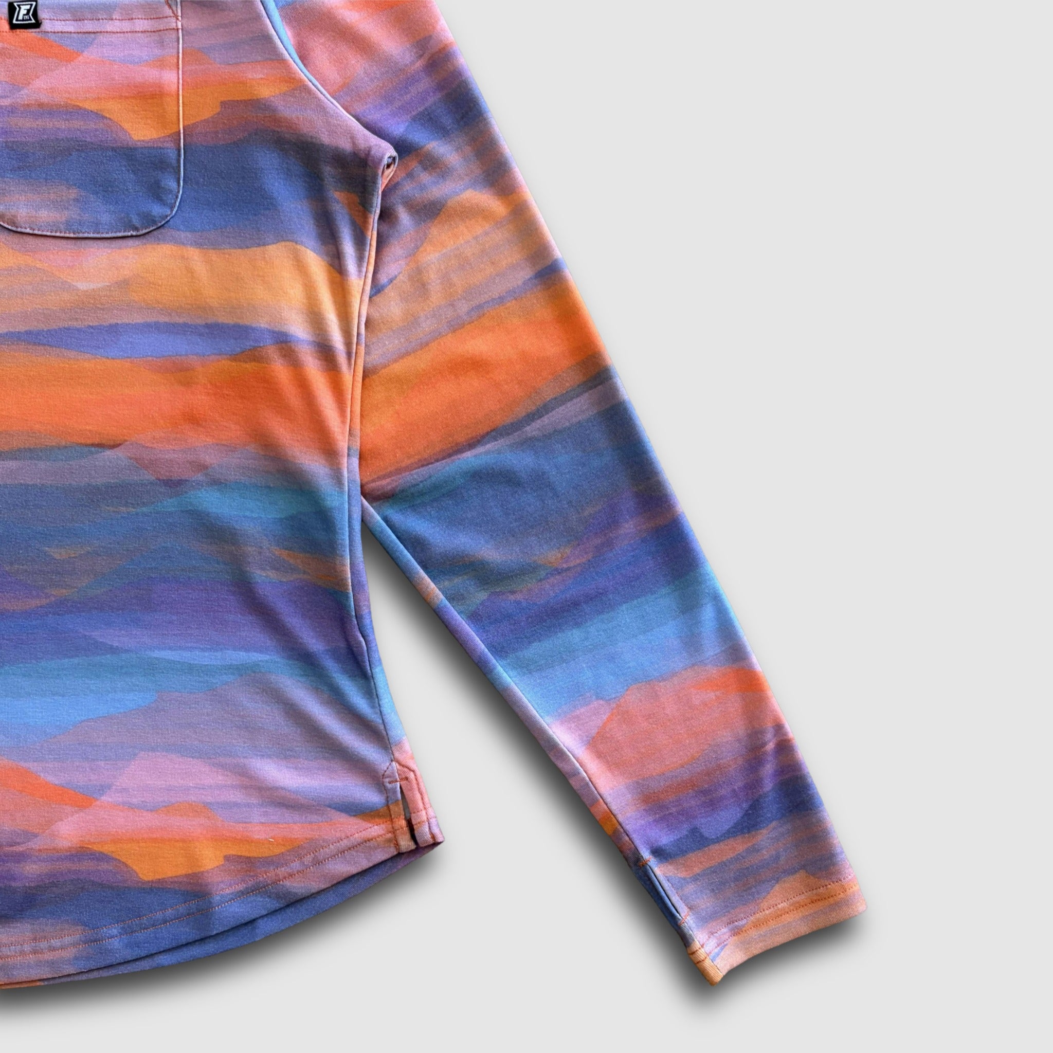 Colorful mountain design sun shirt with long sleeves on a light gray background