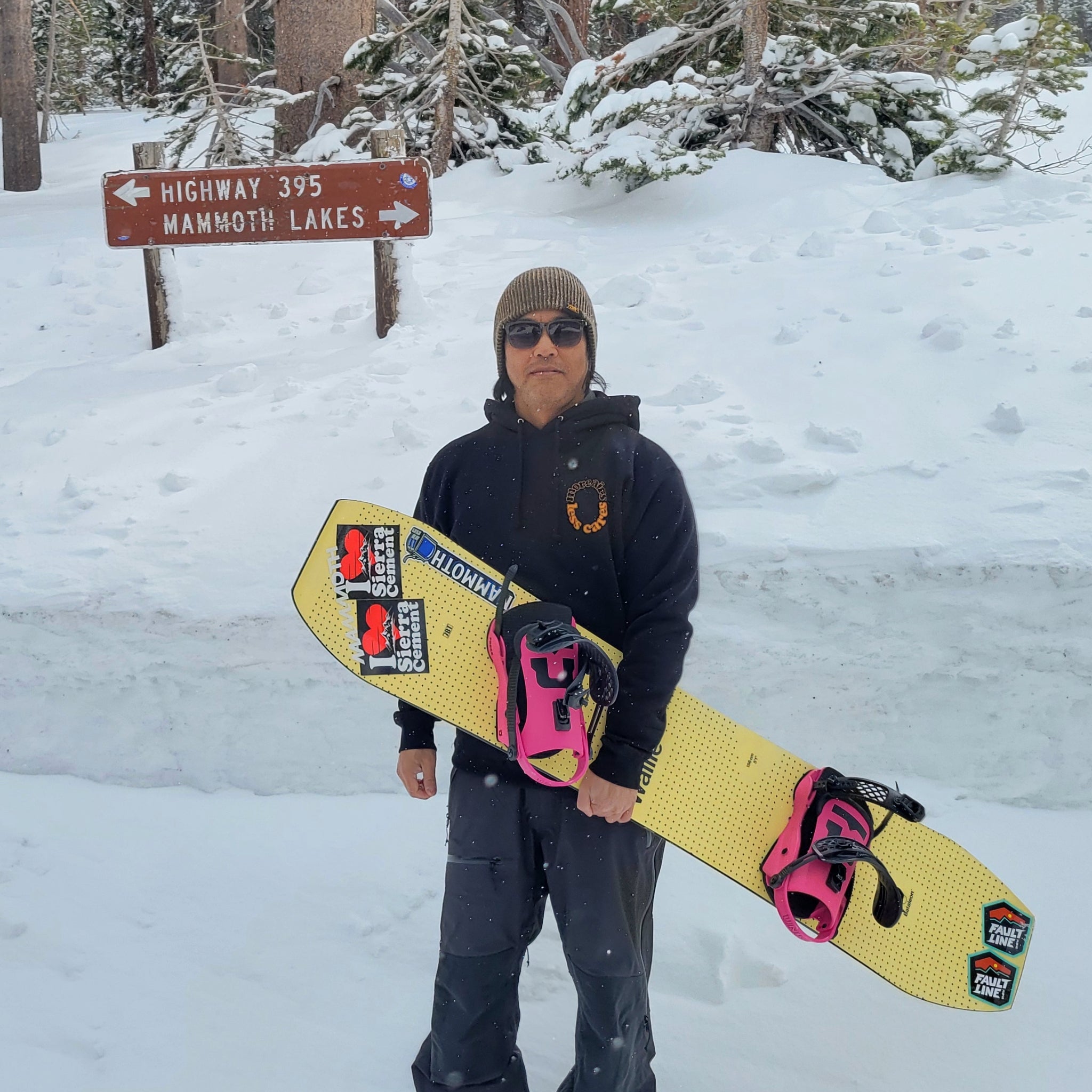 Front view of a snowboarder wearing the More Airs heavyweight hoodie from Faultline395