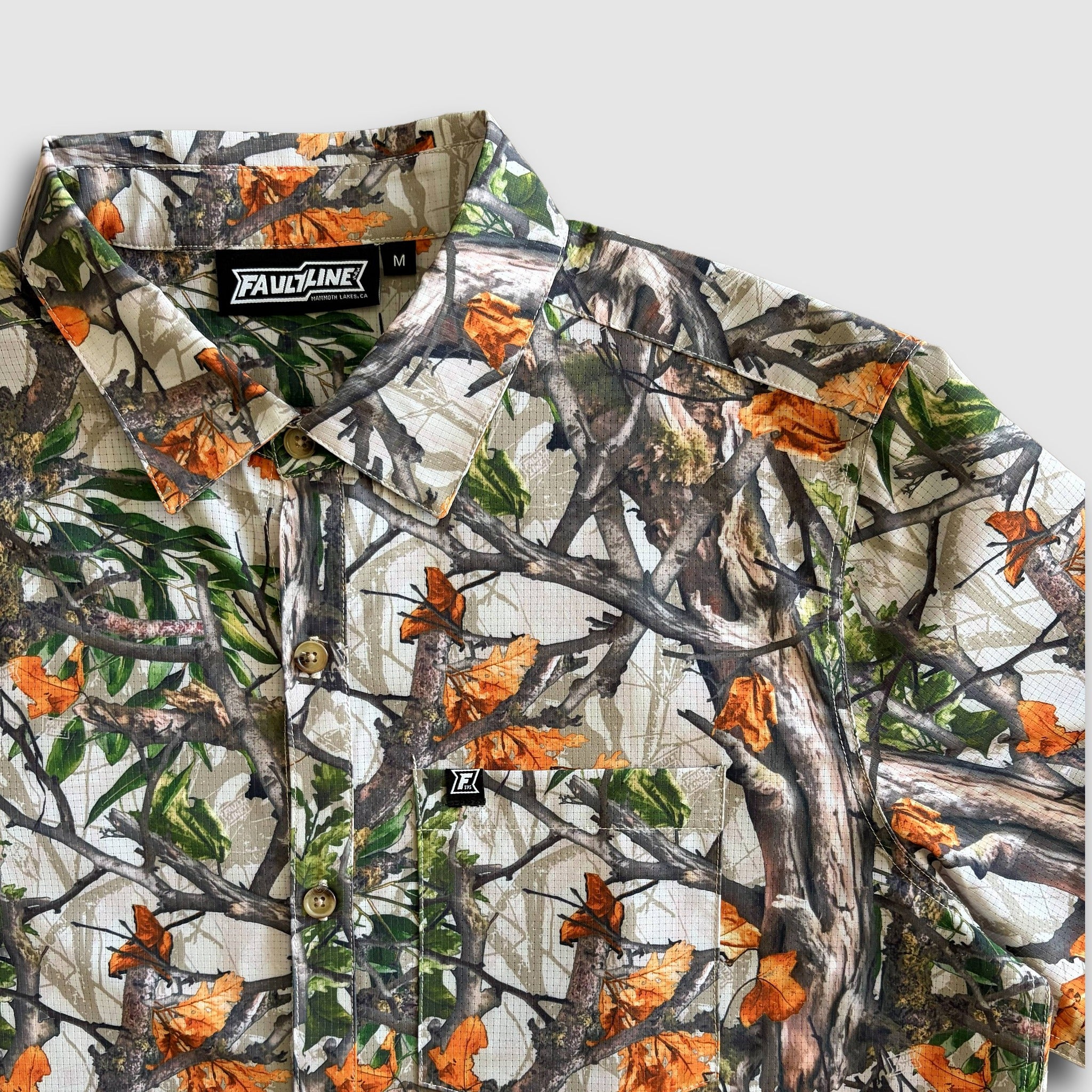 Camouflage-patterned shirt with Faultline395 branding on a white background