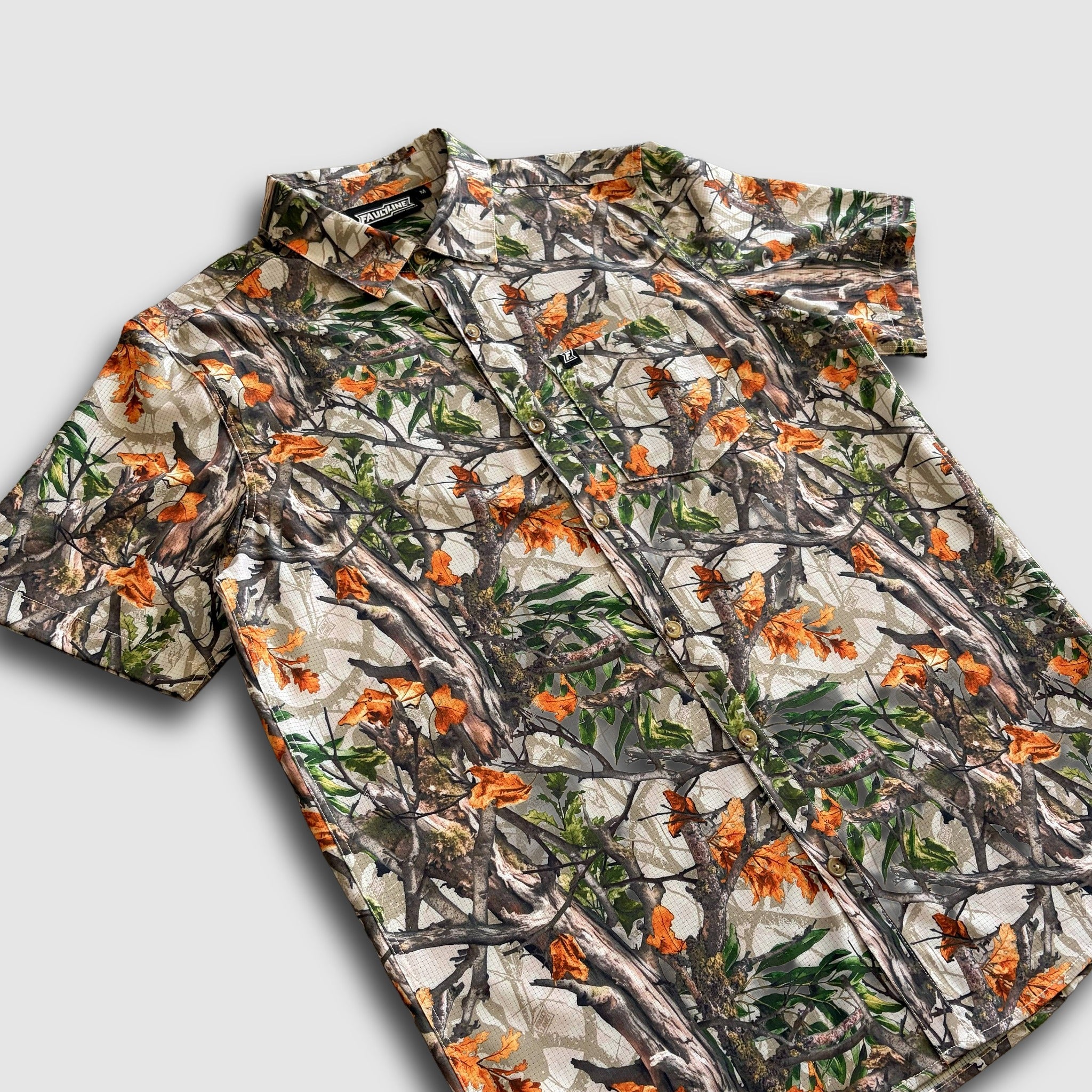 Camo-patterned shirt on a light gray background