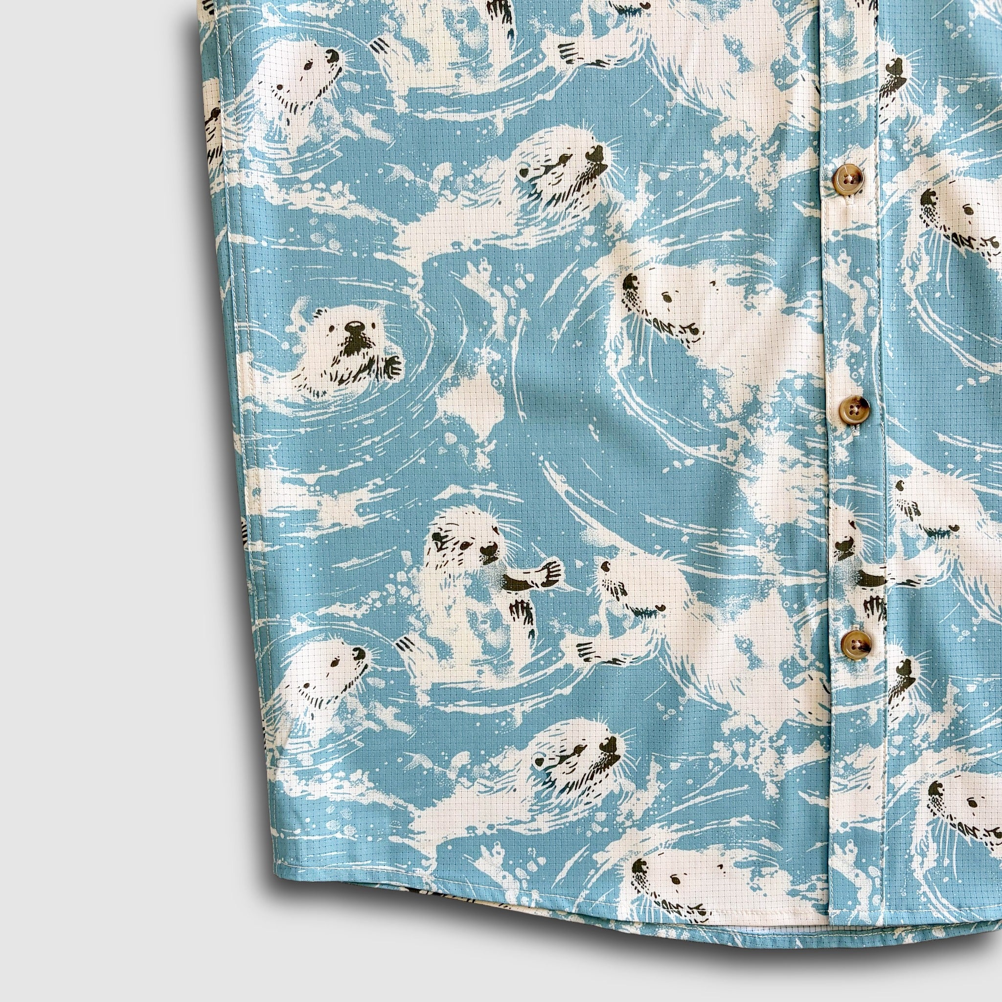 Detail short of micro perforated fabric used on a shirt with a sea otter print design