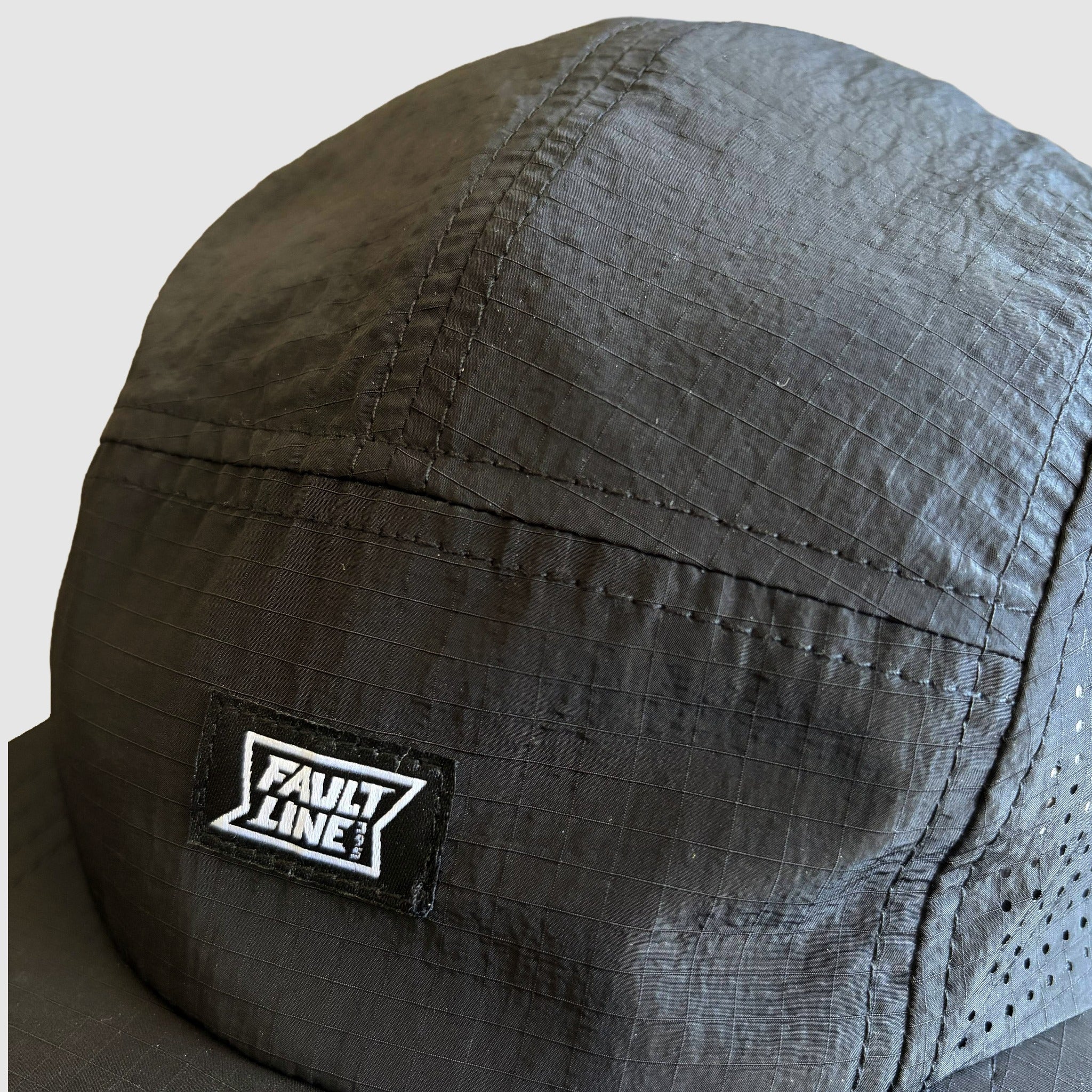 Details shot of the black ripstop fabric used on the Faultline395 5-Panel cap
