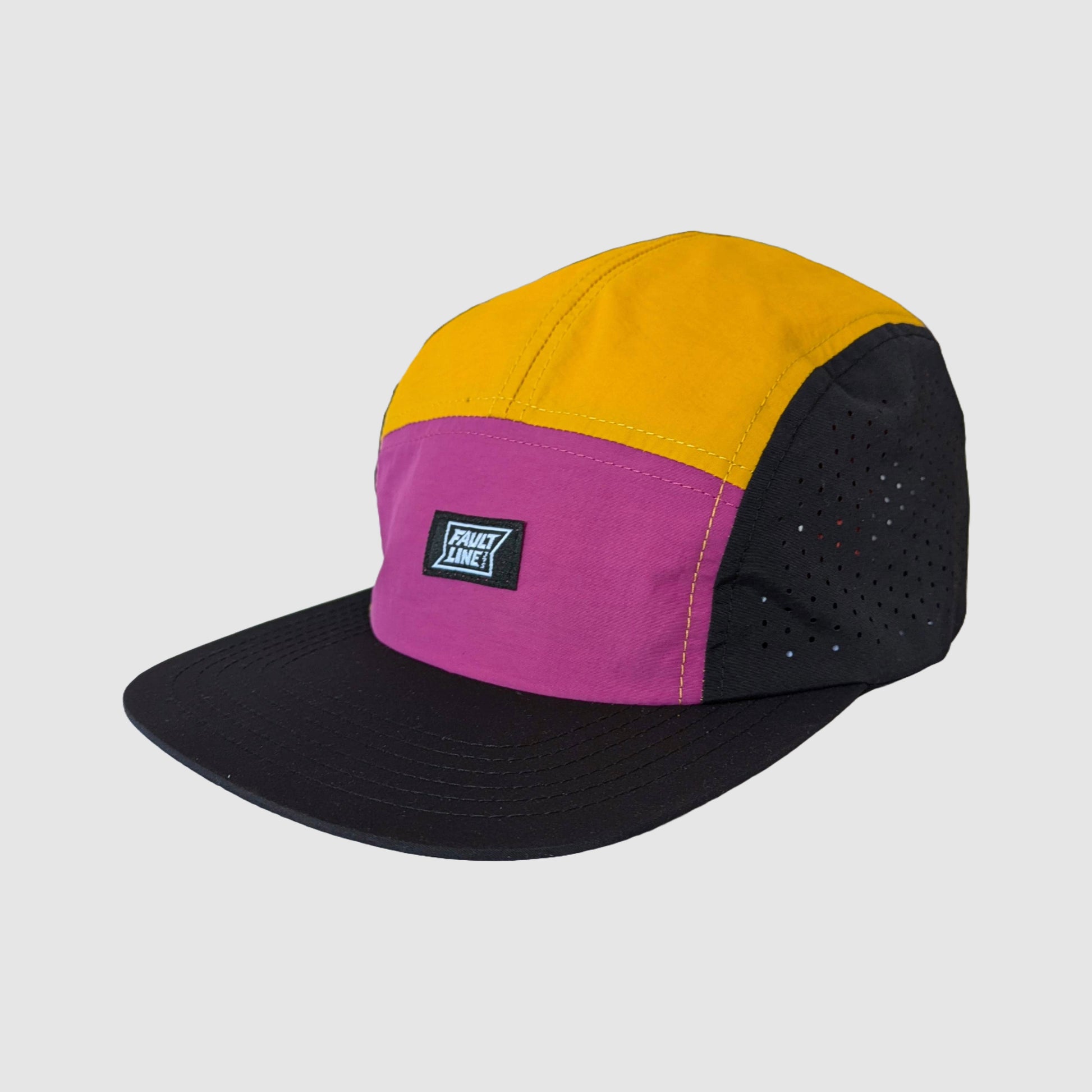 Performance camper hat with laser etched holes on the side panels