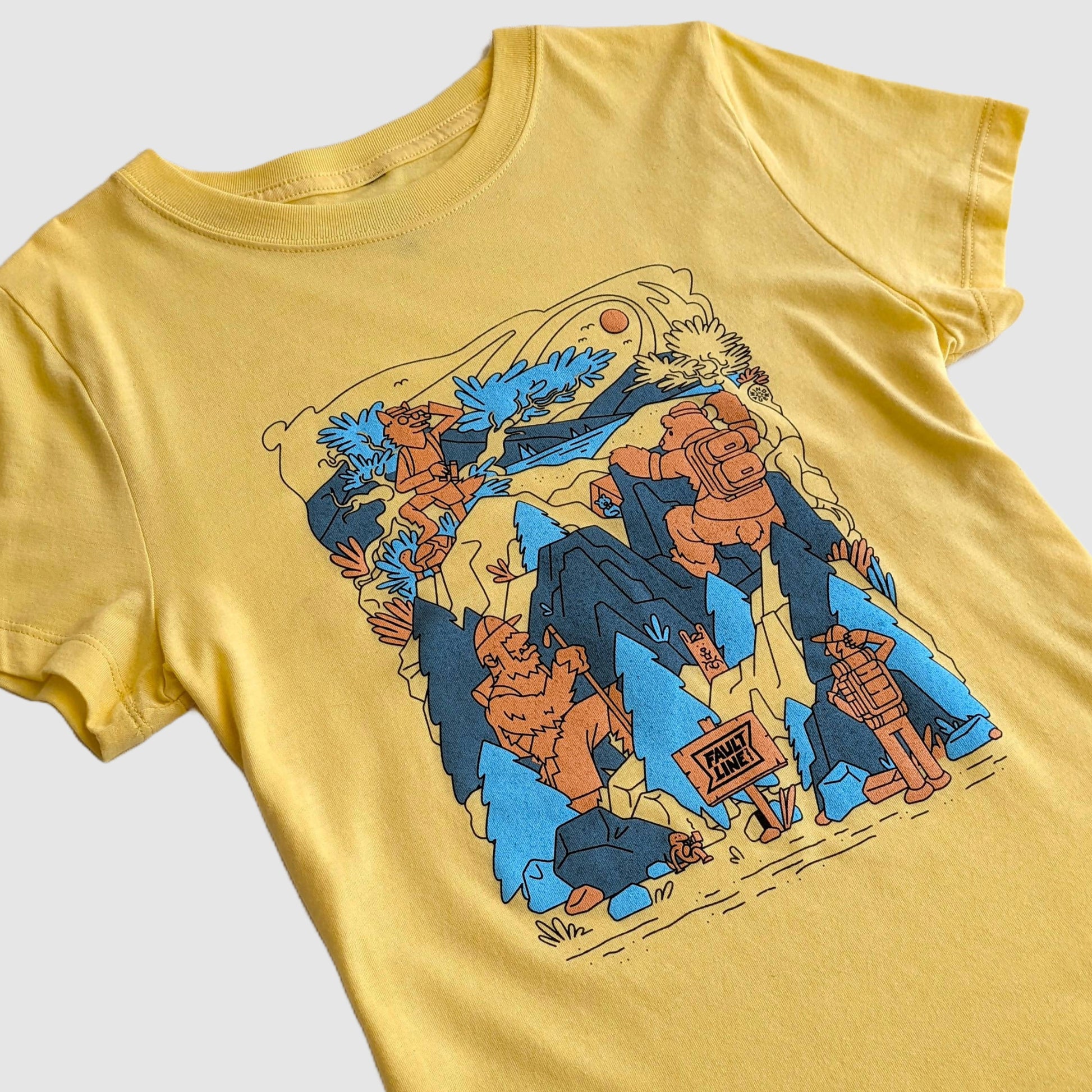 Detailed shot of the artwork on the wild friends t-shirt including a coyote, a yeti, and a mountain climbing bear.
