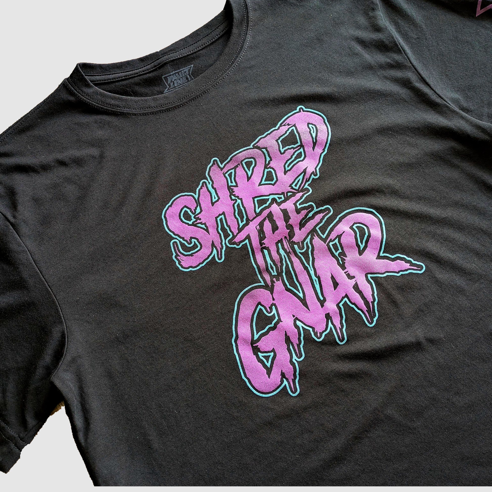 Detailed view of the Shred The Gnar design printed on a sustainable t-shirt.