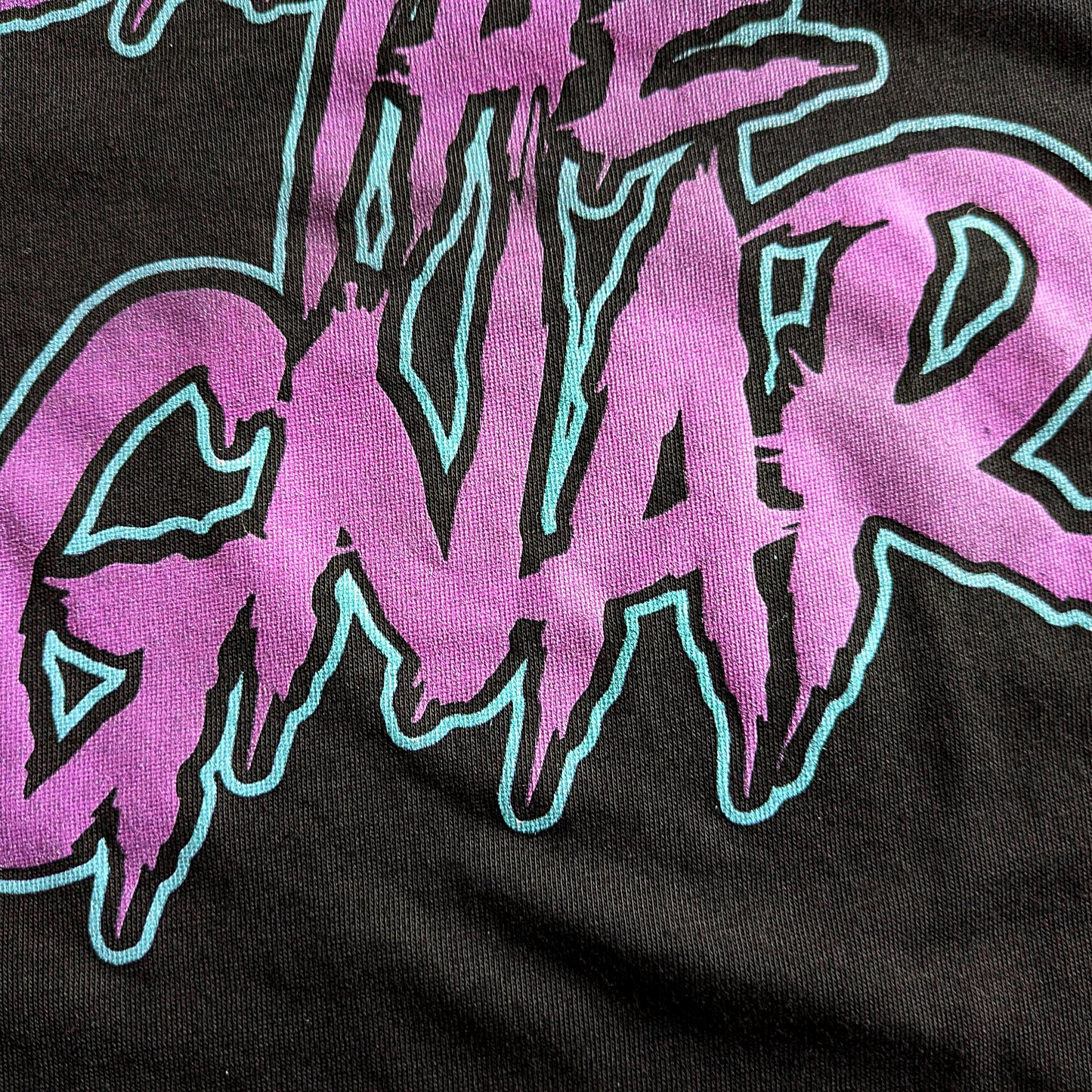 Close up of the purple and teal Shred The Gnar t-shirt design from Faultline395.