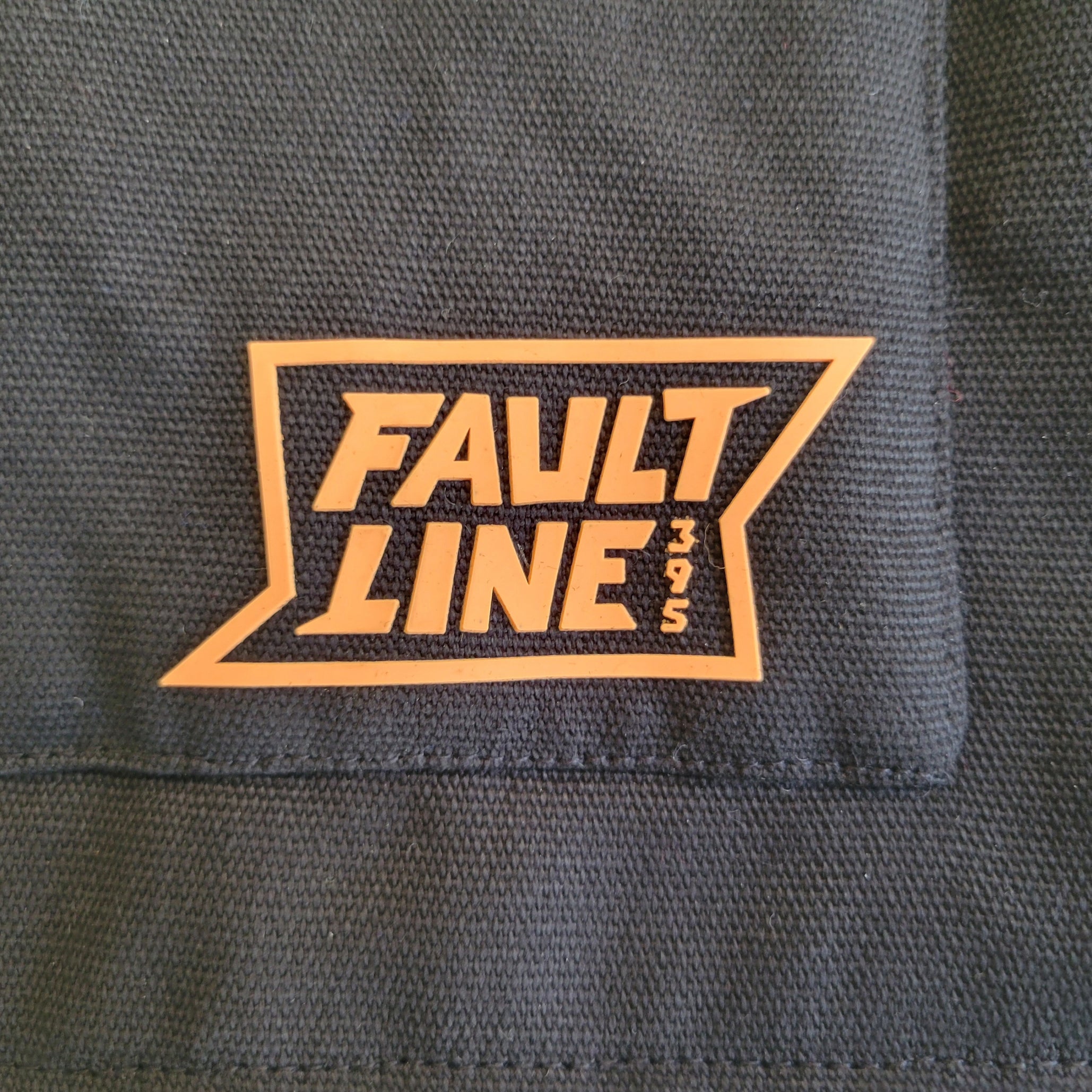 Detailed close-up on the Faultline395 logo on our work vest