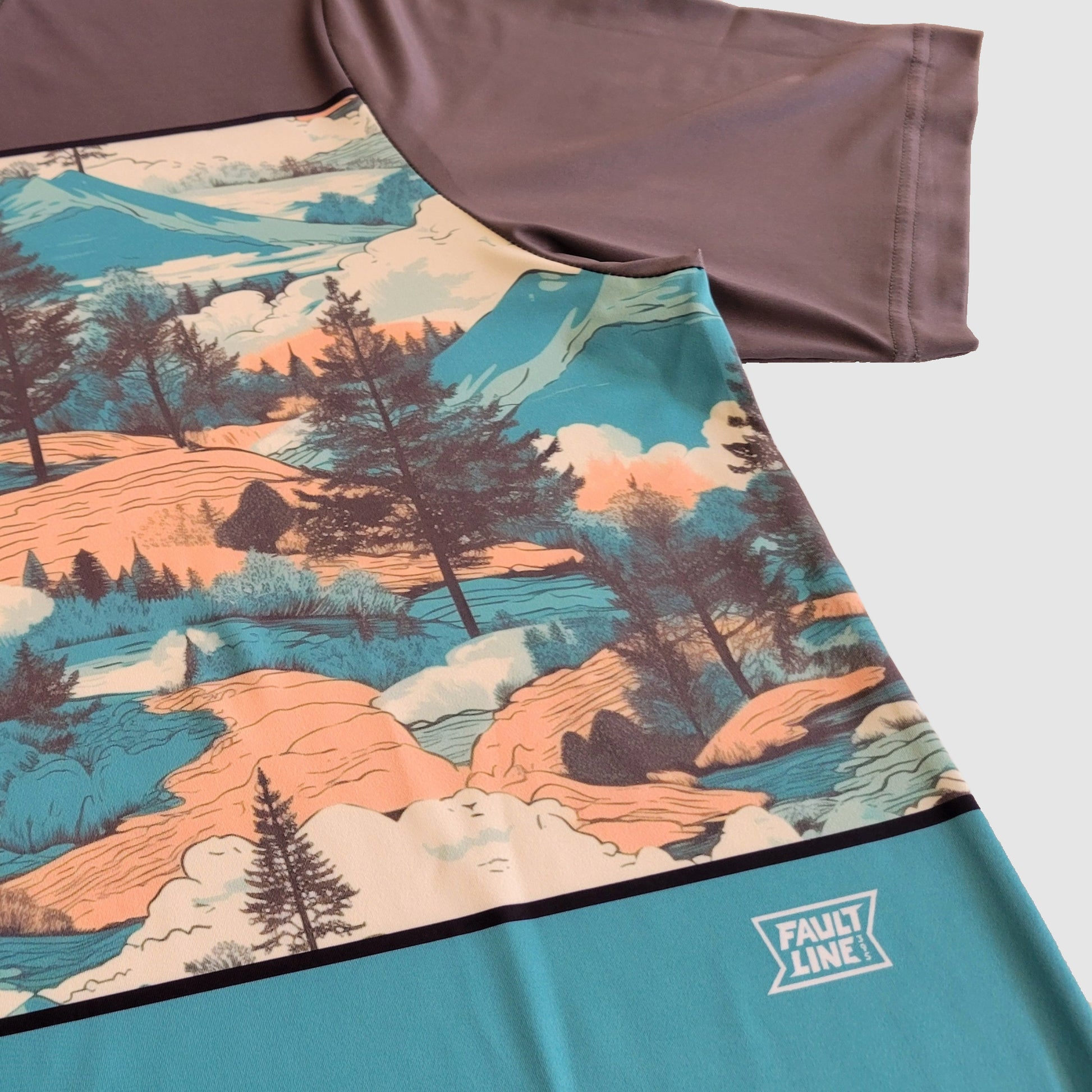 View of the detailed mountain landscape design and Faultline395 logo on the Crowley performance t-shirt.