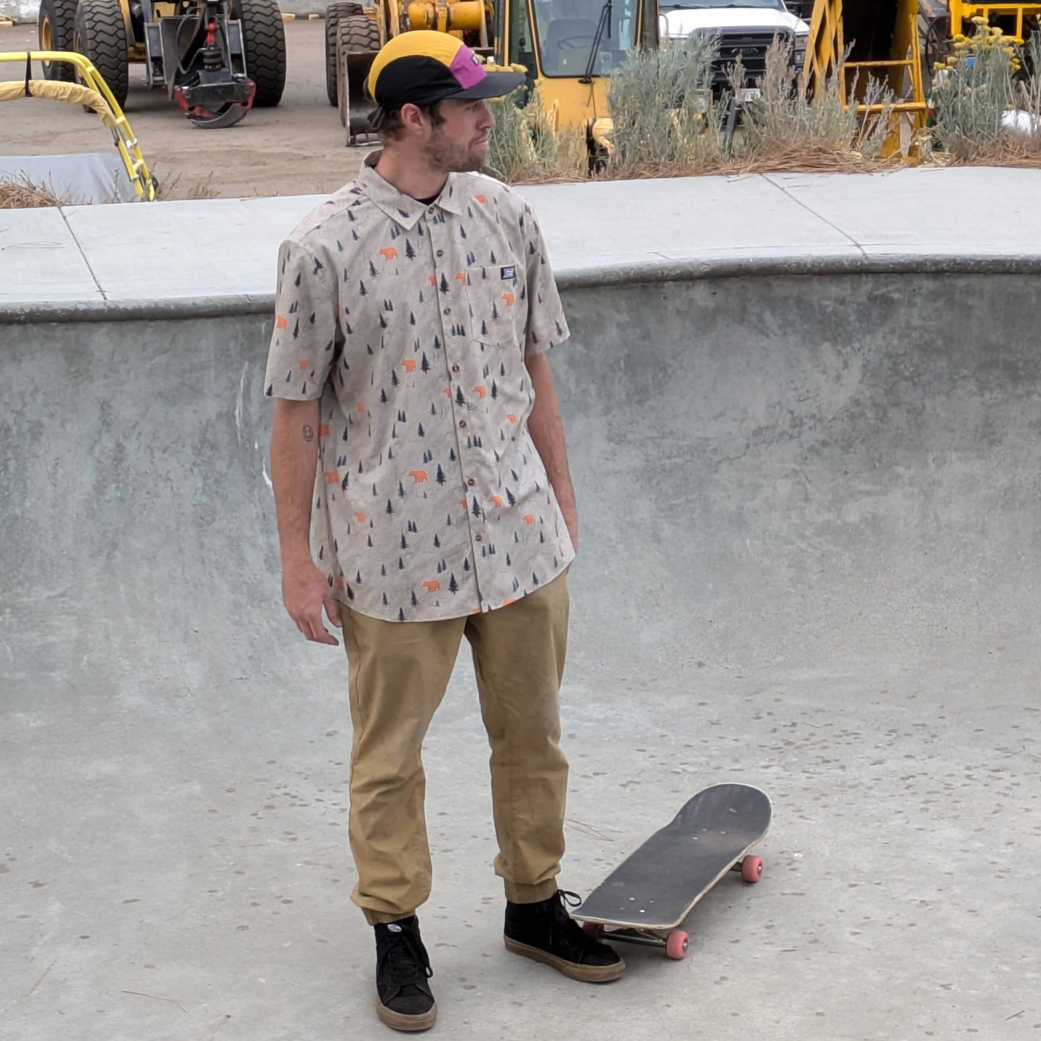 Skateboarder wearing the Faultline395 Ultralight 5-Panel hat in the boysenberry and gold colorway
