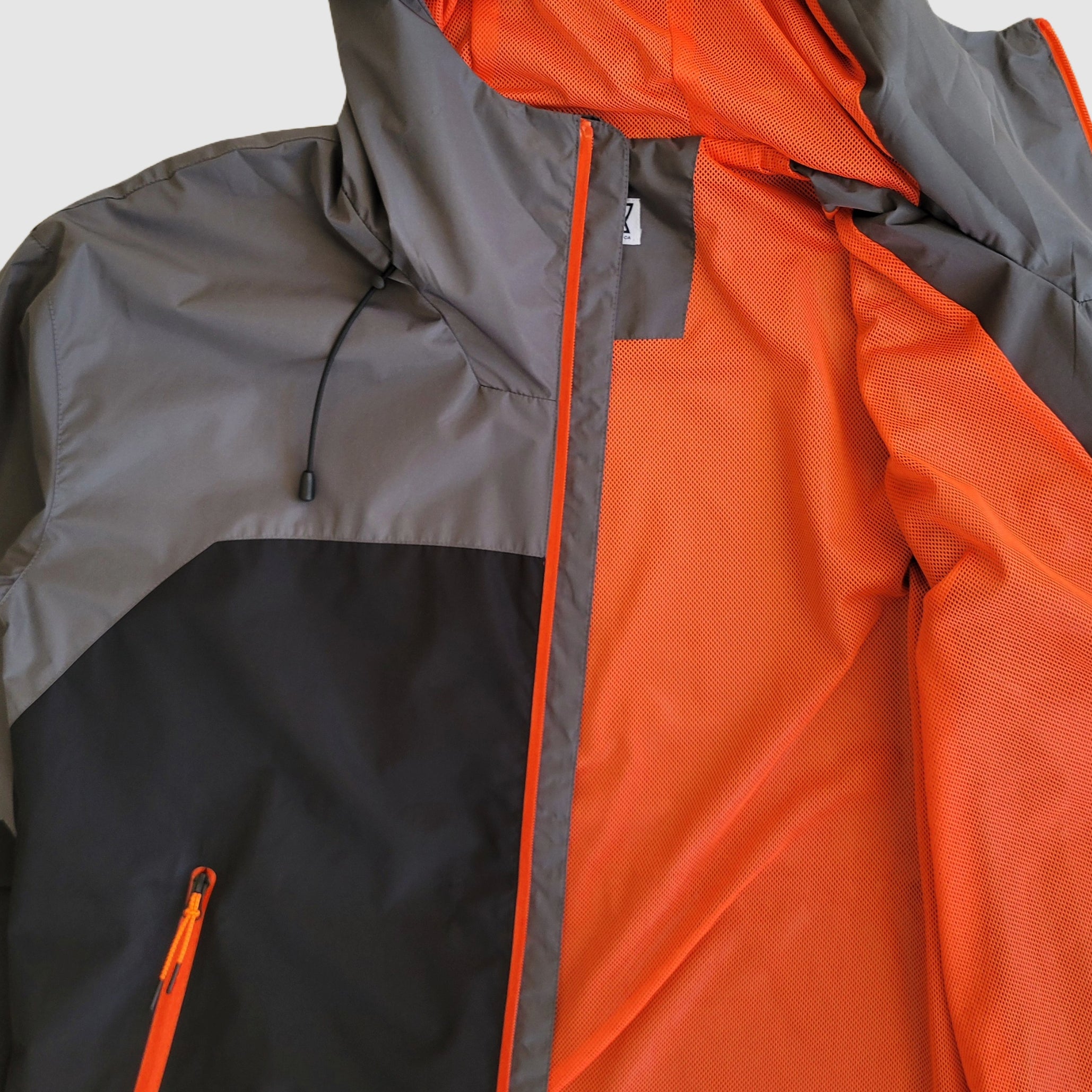 View of the bright orange mesh lining inside the Forest Trail waterproof jacket.