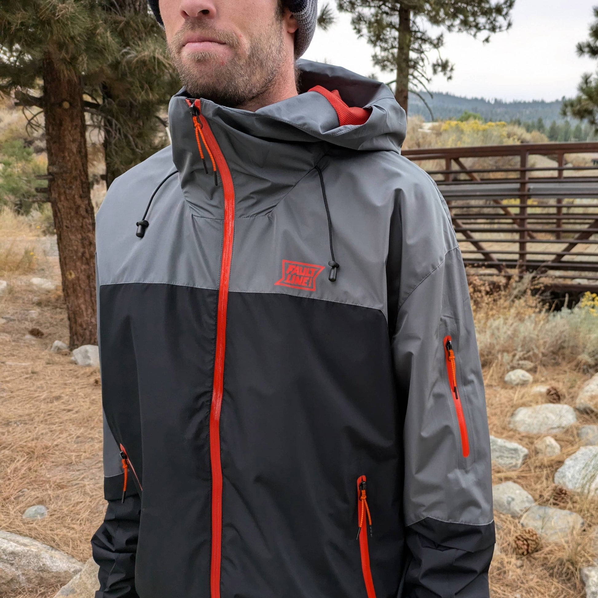 Closeup of a person wearing the waterproof Forest Trail jacket from Faultline395, demonstrating the true to size fit.