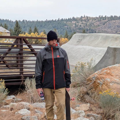 Skateboarder wearing the Forest Trail Jacket in Black and Grey, showing off its comfort and versatility.