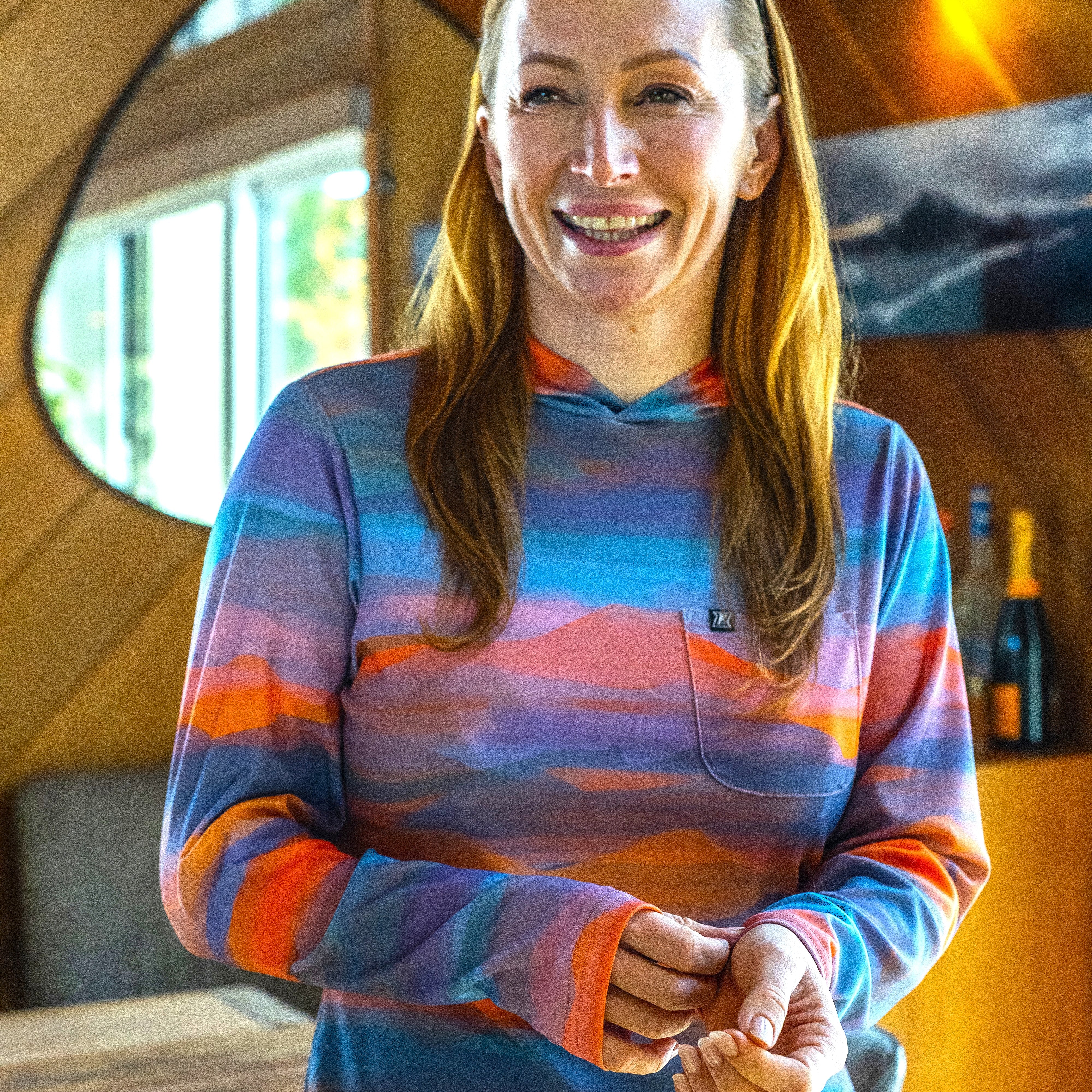 Woman wearing a performance sun hoodie from Faultline395