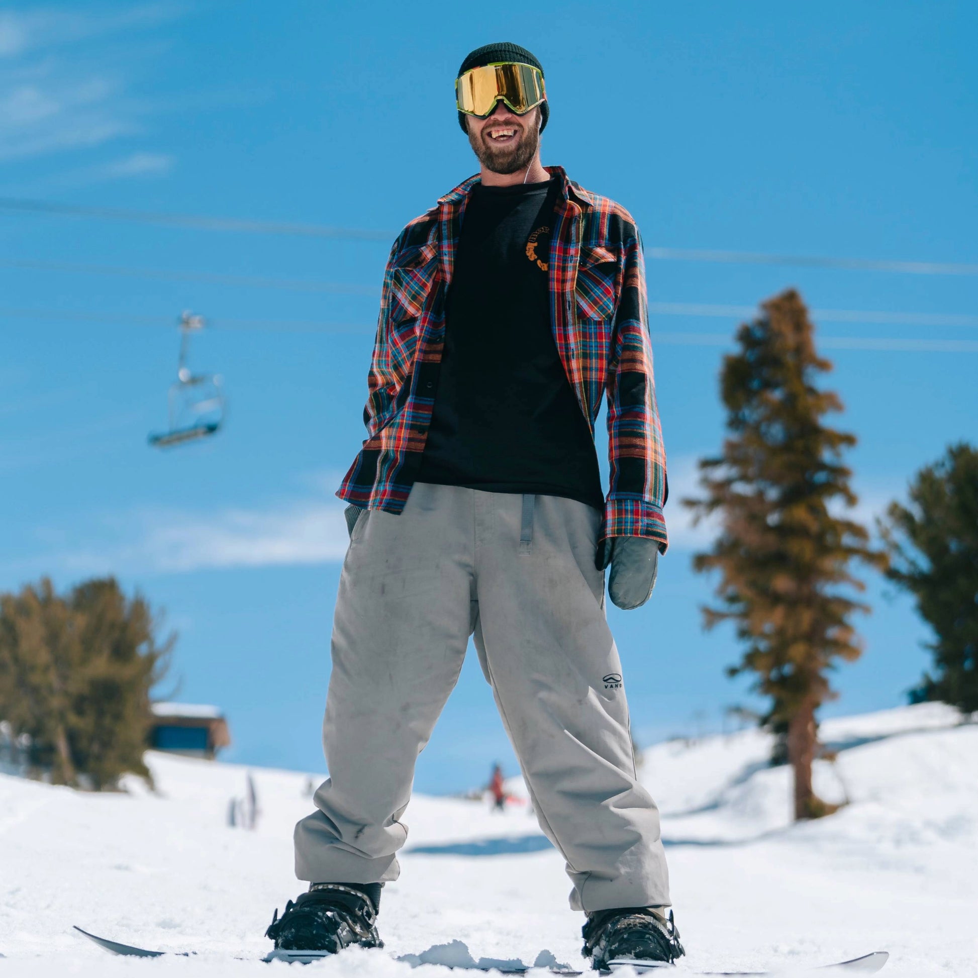 Snowboarder wearing the Faultline 395 McCoy Flannel Shirt designed for outdoor and casual wear