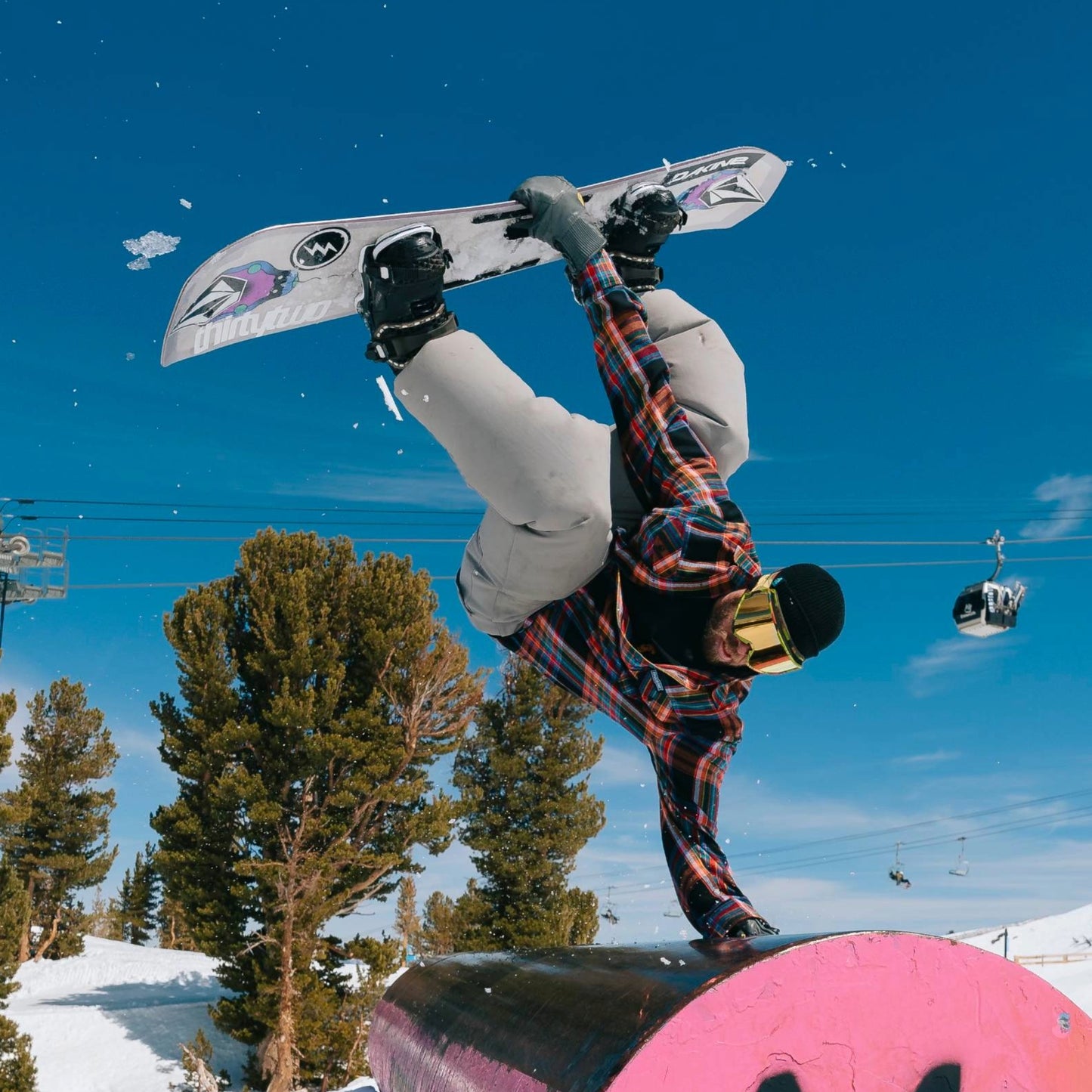 Snowboarder doing a hand plant in the Faultline395 McCoy flannel